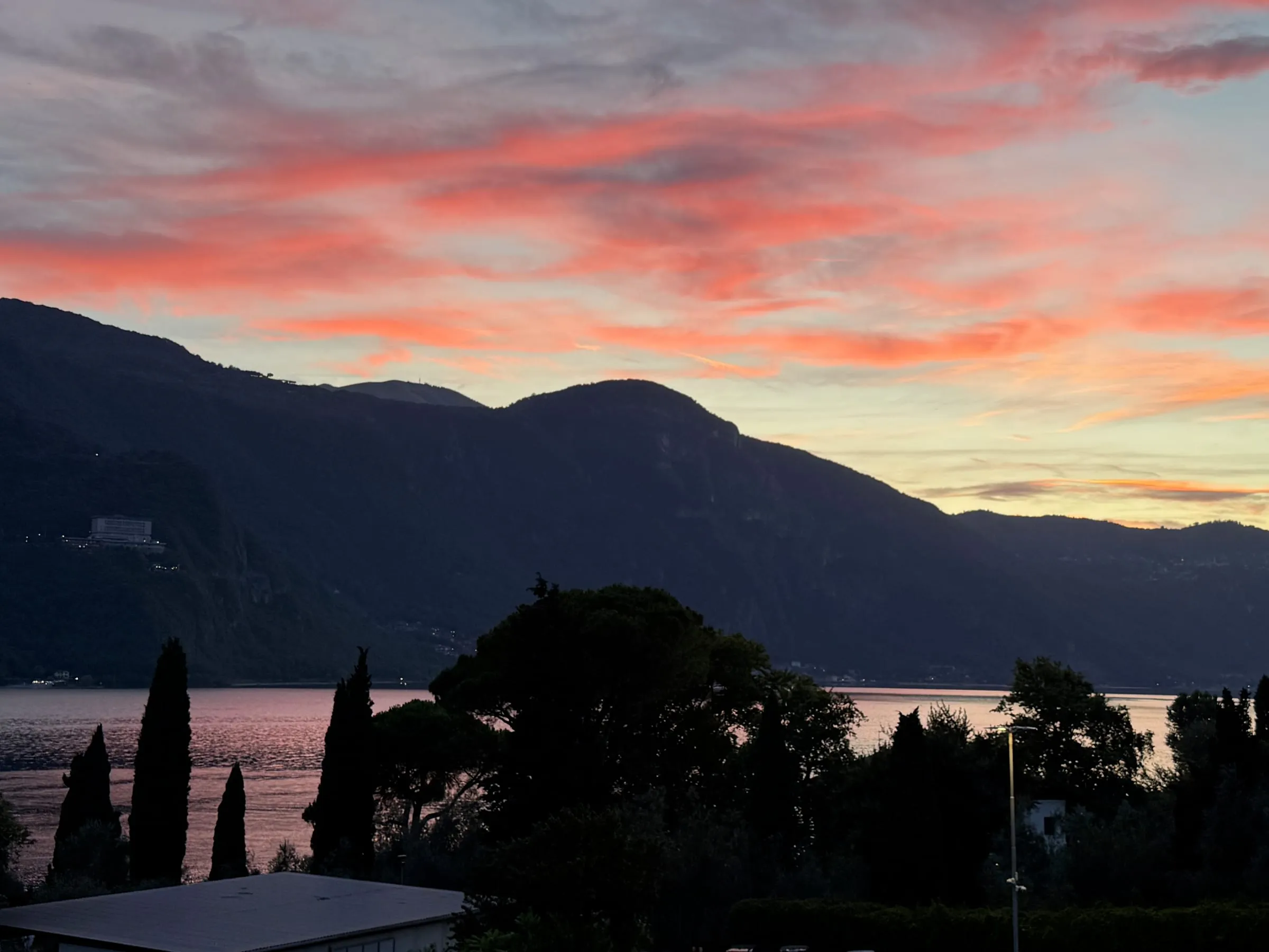 Pink clouds over Lake Como at dusk, seen from Abbadia Lariana